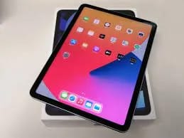 A tablet sitting on top of a white box